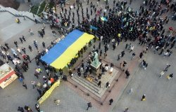 Odessa, Ukraine February,16,2022 Unity Day of Ukraine People carry a huge flag of Ukraine and Belarus near the monument to Duke de Richelieu . Taken from a drone.