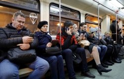 People sitting in a crowded train car