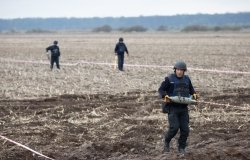  Ukrainian rescuers clear mines at the site of recent fighting.