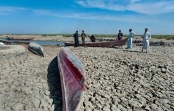  Boats on dried cracked earth during a drought in the Southern Marshes of Iraq.