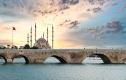 Sabanci Central Mosque and Stone bridge in Adana, Turkey, and the view of Seyhan river with sunset sky. Landmarks in the city of Adana, Turkey