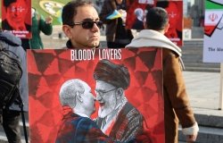 Kyiv, Ukraine - 28 October 2022: Iranian man with political banner in hands protests against dictatorship and ayatollah regime in Iran at street rally. reportage editorial photo