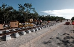 Workers install rails for the Mayan Train in Section 4