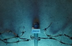 Microphone held by barbed wire