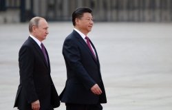 Russian President Vladimir Putin and Chinese President Xi Jinping walking side by side