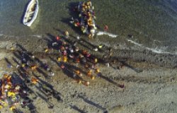 Aerial image from above with Syrian migrants/refugees as they arrive from Turkey on a boat near Molyvos, Greece