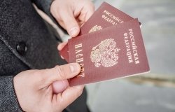 Two russian passports in hand. Russian official document on outdoor background