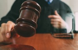 judge in a courtroom with the gavel