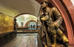 A Soviet border guard and his dog (1938) at the Revolution Square subway station in Moscow.