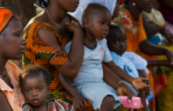  Portrait of a young mother and her baby daughter during a community meeting, at the Bissaque neighborhood in the city of Bissau, Guinea Bissau.